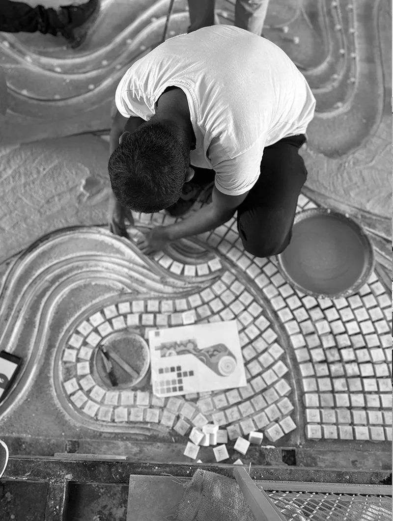 Craftsperson installing a mosaic detail